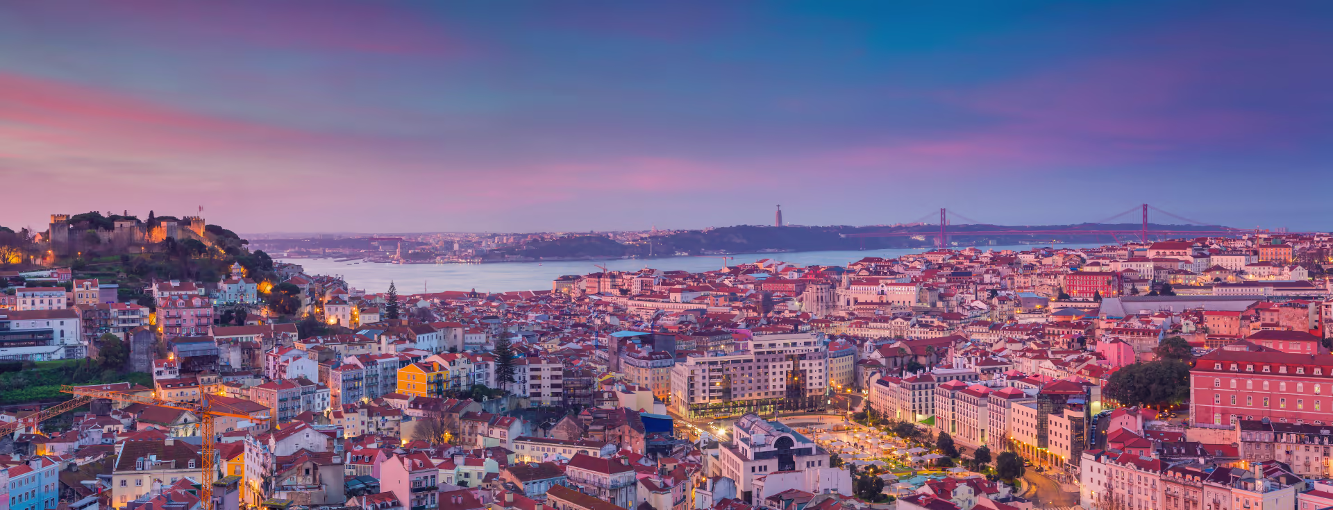 Panoramic view of Lisbon's iconic Belém Tower and waterfront properties showcasing the city's historic architecture and modern real estate opportunities